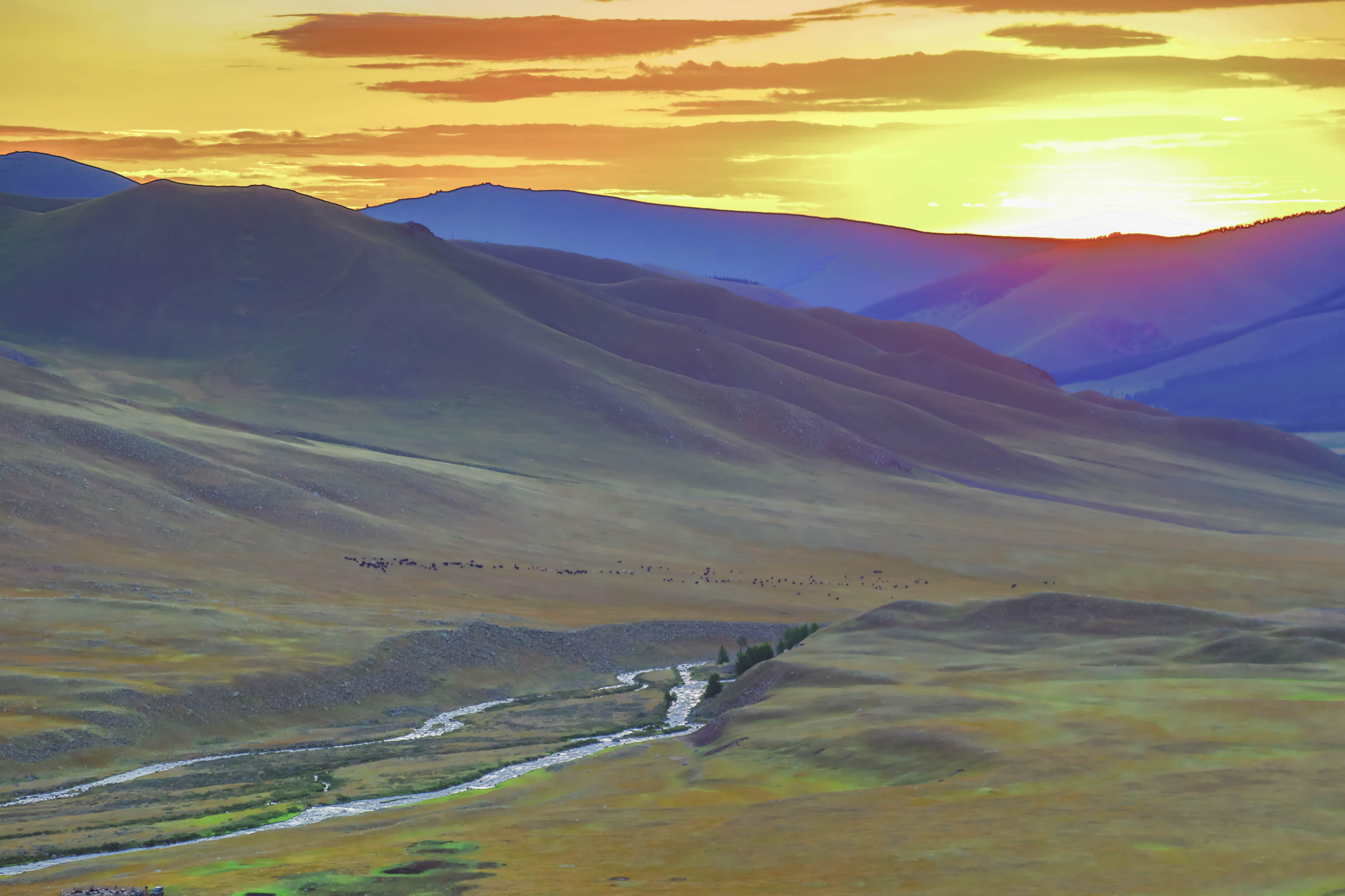 Sunset over stream and valley